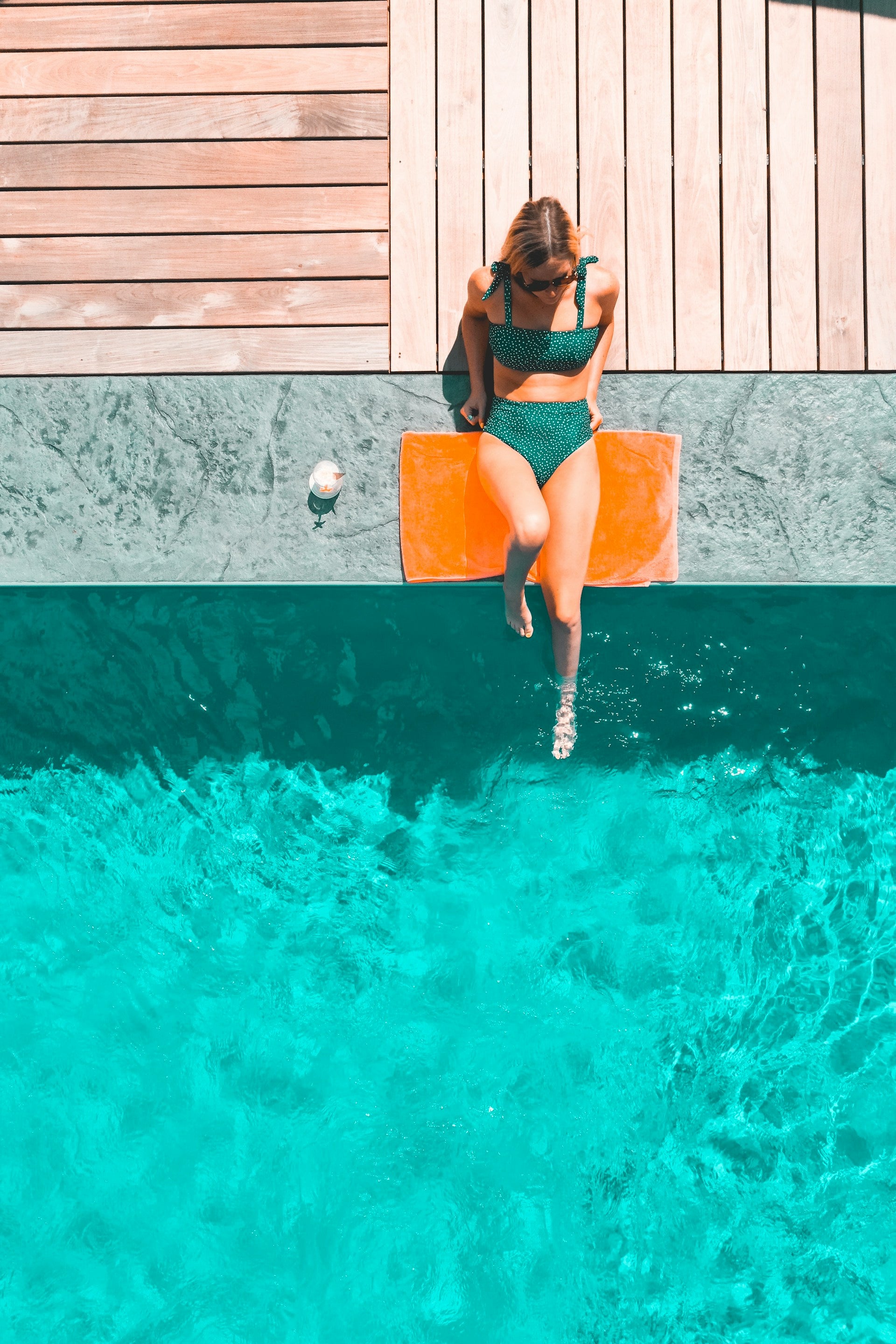 picture of woman sunbathing in pool